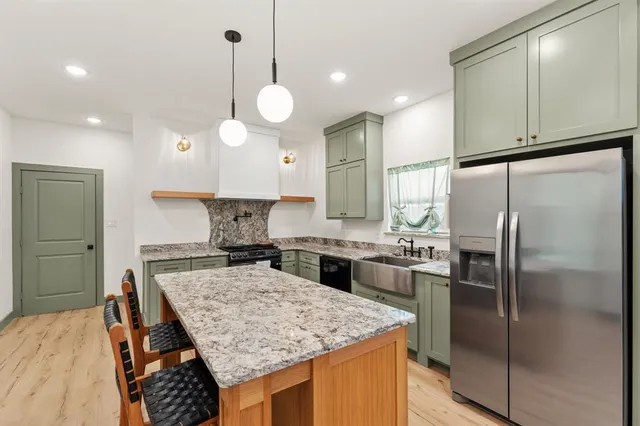 a kitchen with a refrigerator a sink and a stove