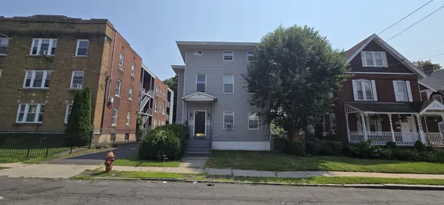 a view of a brick building next to a yard