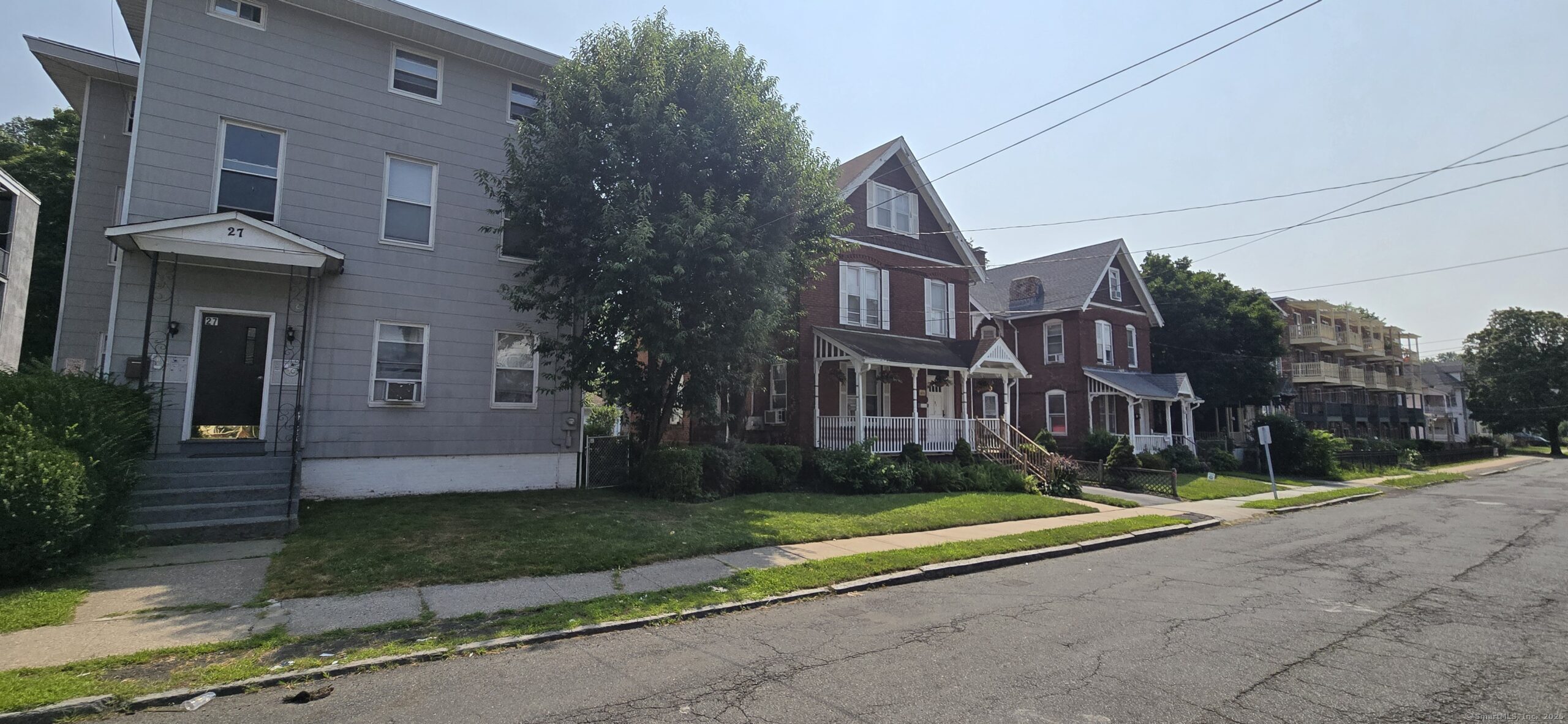 27 Allen Place Hartford, CT 06106 - Photo 2 of 11 a view of a brick house next to a yard with road