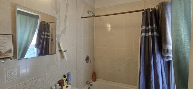 a bathroom with a shower and a tub