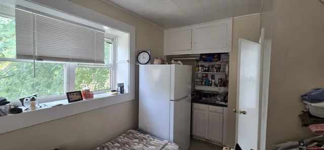 a kitchen with a refrigerator and a window