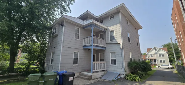 a view of a patio with couches and a table and chairs and a fire pit