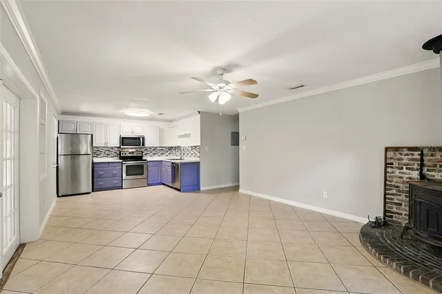 a kitchen with stainless steel appliances granite countertop a refrigerator and a stove top oven