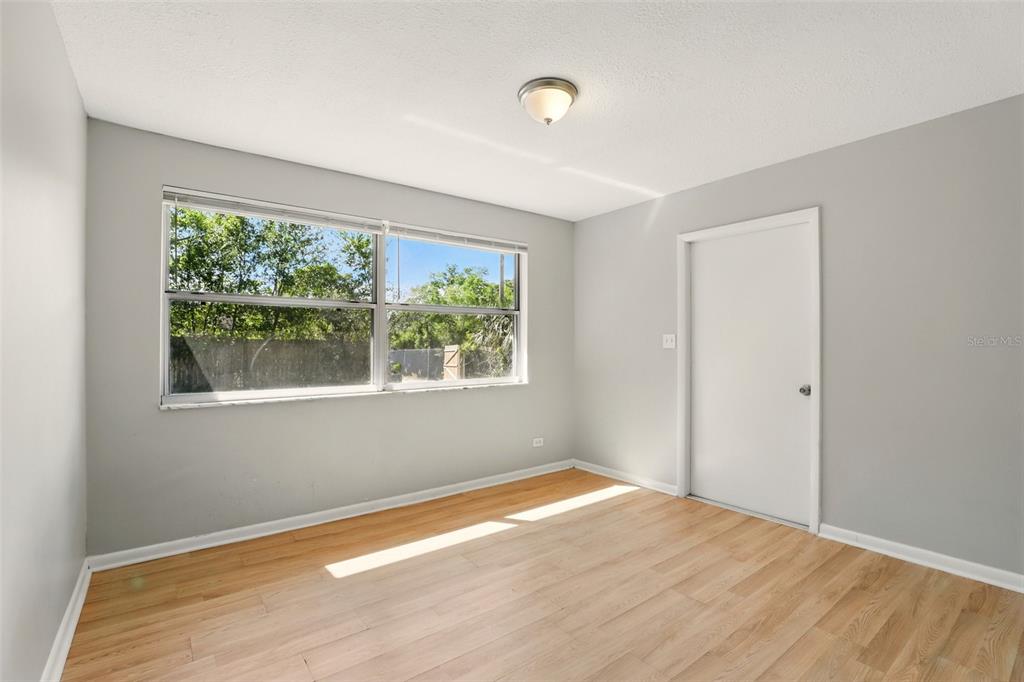 1617 Acacia Road Apopka, FL 32712 - Photo 18 of 30 a view of empty room with wooden floor and fan
