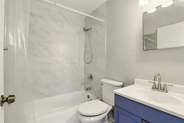 an empty room with wooden floor and window