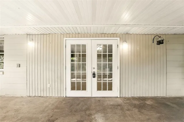 an empty room with fireplace and fan