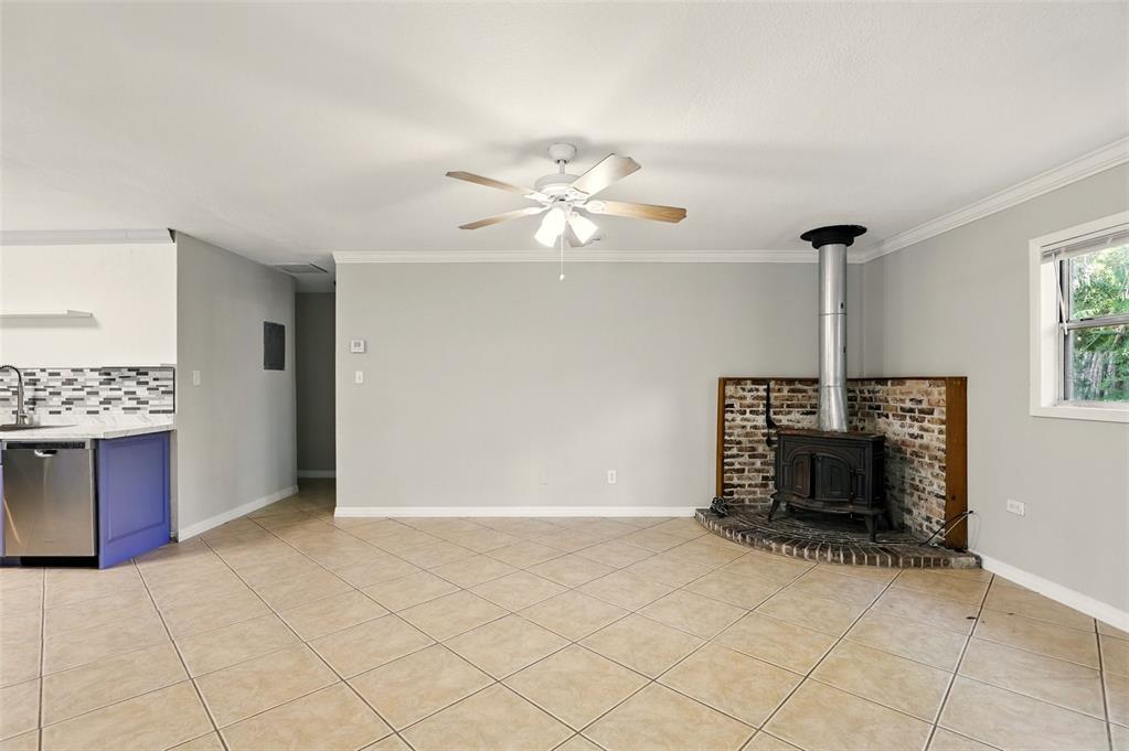 1617 Acacia Road Apopka, FL 32712 - Photo 7 of 30 an empty room with fireplace and fan