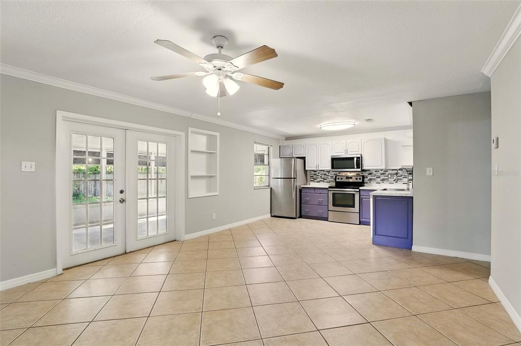 1617 Acacia Road Apopka, FL 32712 - Photo 10 of 30 a large kitchen with stainless steel appliances granite countertop a stove top oven a sink dishwasher and a refrigerator with wooden floor