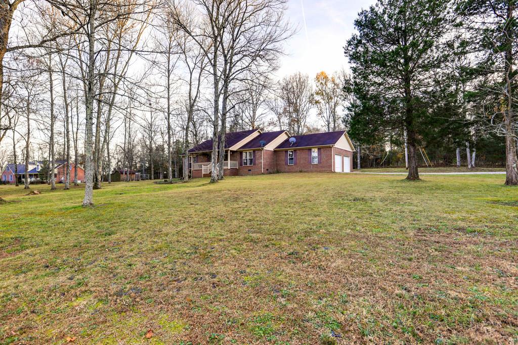 5056 Joe Peay Road Spring Hill, TN 37174 - Photo 5 of 30 a large tree in middle of green field