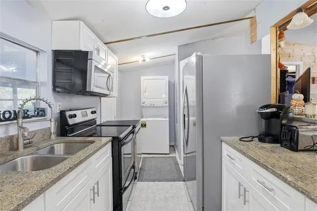 a bedroom with a bed and a dresser with wooden floor