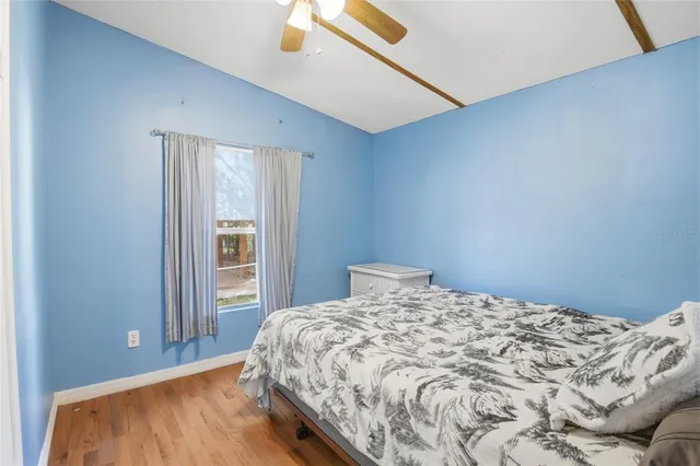a view of a room with wooden floor and windows