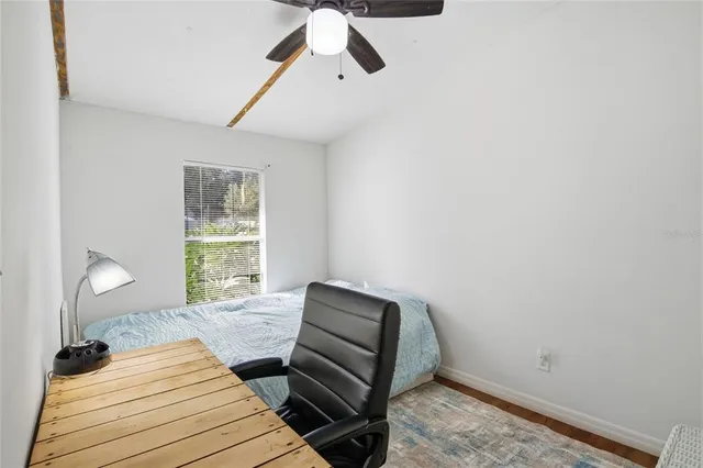 a bedroom with a bed and a window