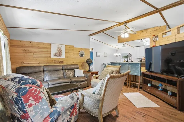 a living room with furniture and a floor to ceiling window