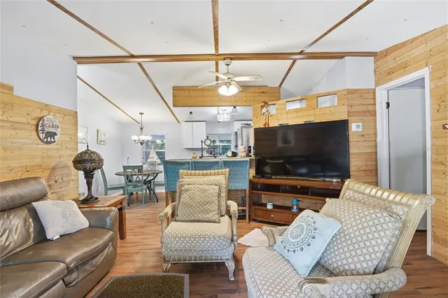 a living room with furniture a rug and a chandelier
