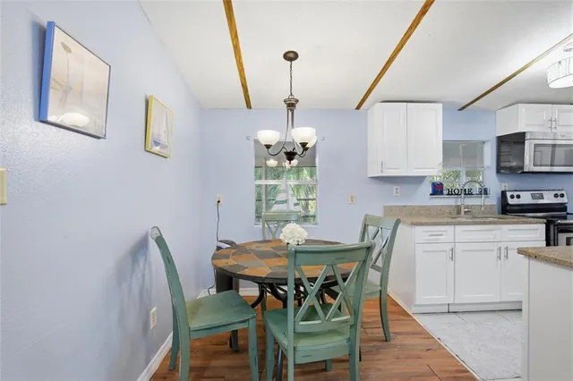 a view of a dining room with furniture wooden floor and chandelier