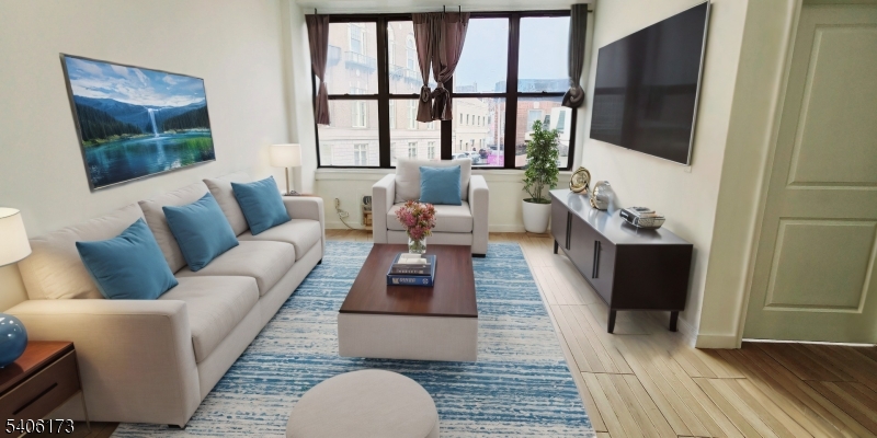 30 Howe Avenue Passaic, NJ 07055 - Photo 2 of 6 a living room with furniture and a flat screen tv