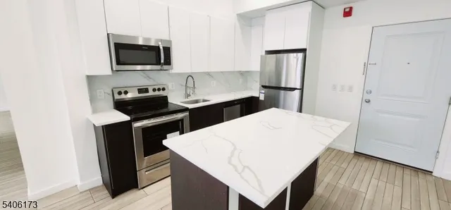 a kitchen with a appliances and cabinets