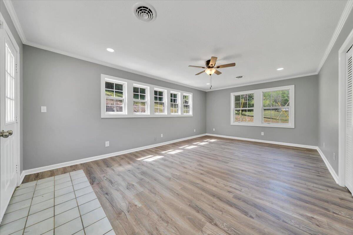 112 Frankie Lane Stuart, VA 24171 - Photo 19 of 57 an empty room with wooden floor and windows