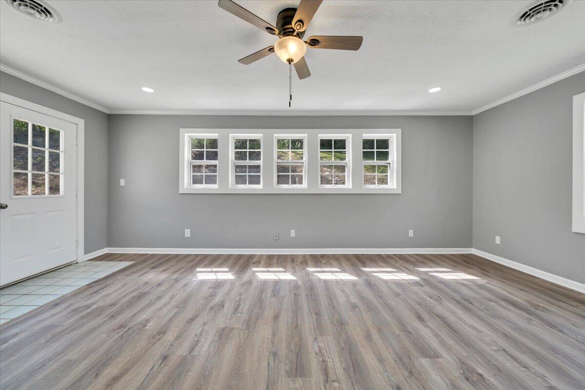 112 Frankie Lane Stuart, VA 24171 - Photo 21 of 57 a view of an empty room with wooden floor and a window