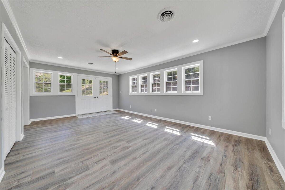 112 Frankie Lane Stuart, VA 24171 - Photo 22 of 57 a view of an empty room with wooden floor and a window