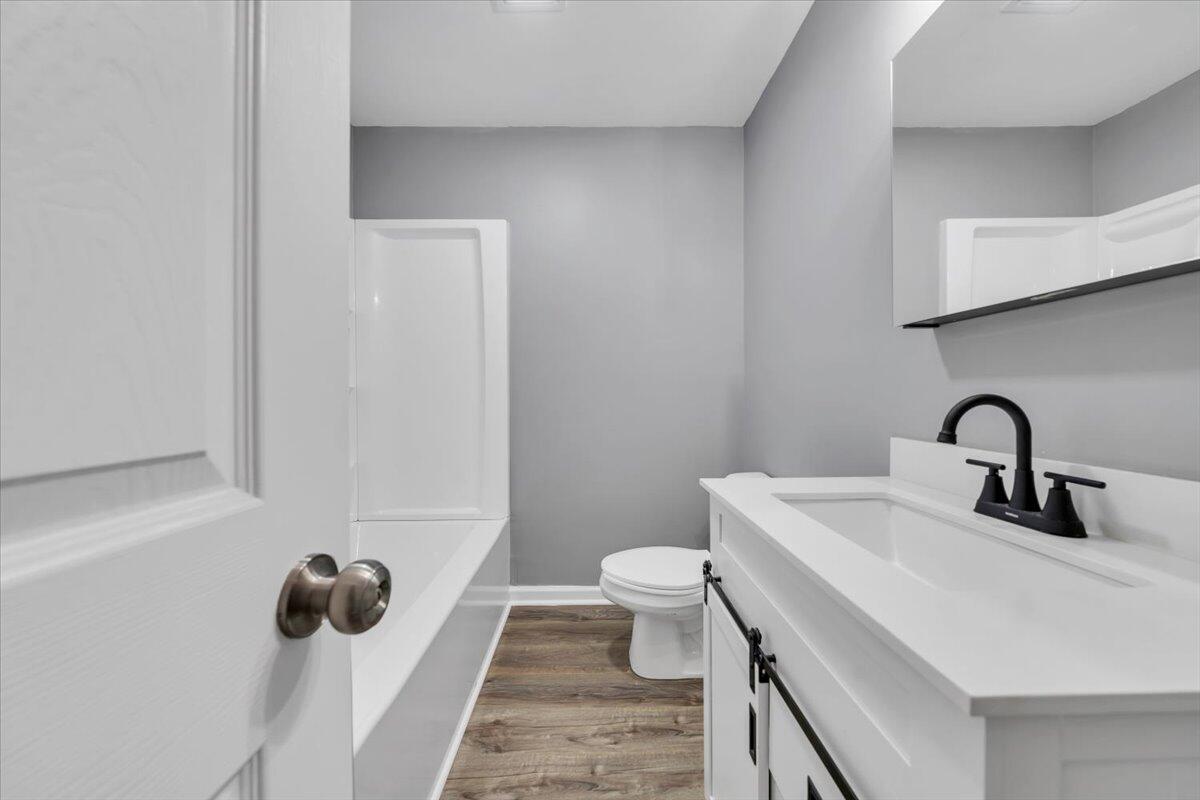 112 Frankie Lane Stuart, VA 24171 - Photo 30 of 57 a bathroom with a sink toilet and mirror