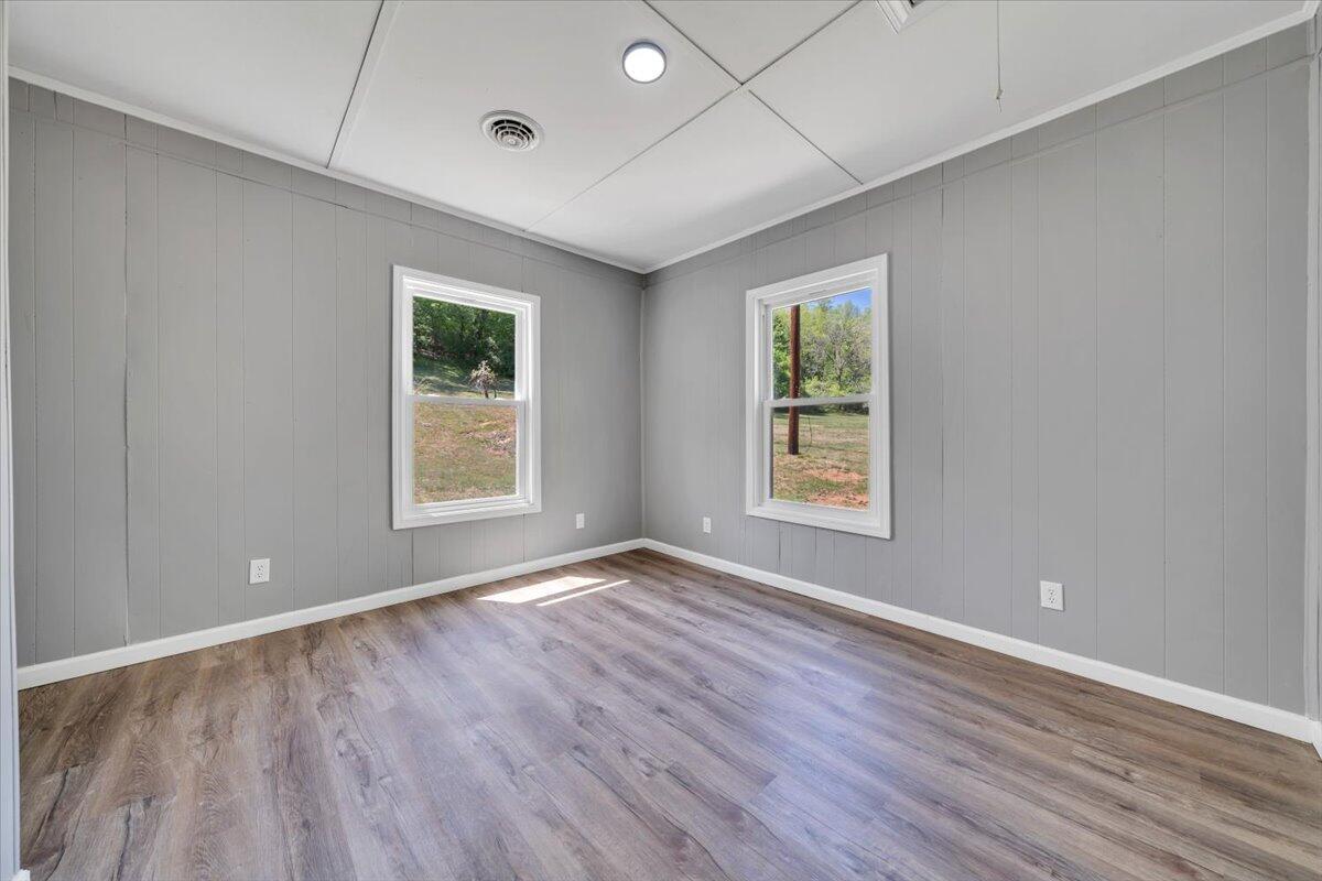 112 Frankie Lane Stuart, VA 24171 - Photo 34 of 57 a view of an empty room with wooden floor and a window