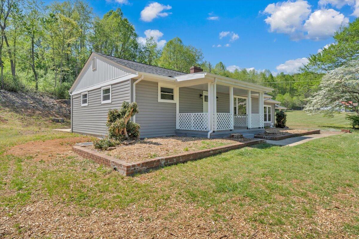 112 Frankie Lane Stuart, VA 24171 - Photo 54 of 57 a front view of house with yard and trees in the background