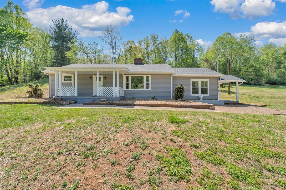 112 Frankie Lane Stuart, VA 24171 - Photo 56 of 57 a front view of a house with a garden and trees