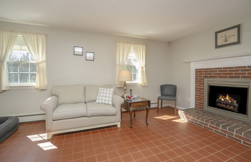22 Elizabeth Street Amesbury, MA 01913 - Photo 11 of 38 a living room with furniture a window and a fireplace