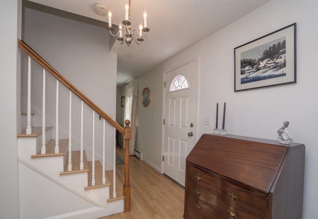 22 Elizabeth Street Amesbury, MA 01913 - Photo 14 of 38 a living room with furniture and a chandelier
