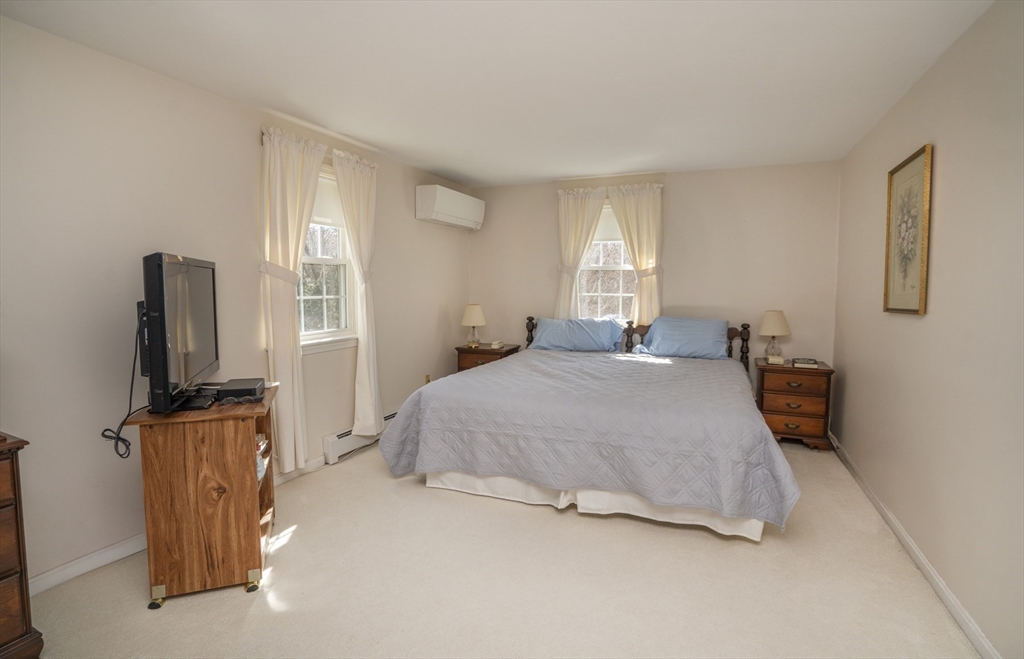 22 Elizabeth Street Amesbury, MA 01913 - Photo 15 of 38 a bedroom with a bed flat screen tv and window