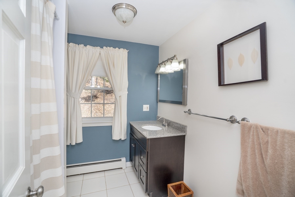 22 Elizabeth Street Amesbury, MA 01913 - Photo 22 of 38 a bathroom with a sink mirror and a toilet