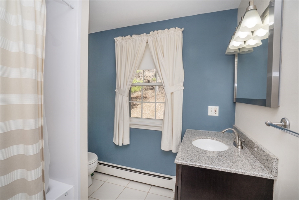 22 Elizabeth Street Amesbury, MA 01913 - Photo 23 of 38 a bathroom with a granite countertop sink a mirror and a shower