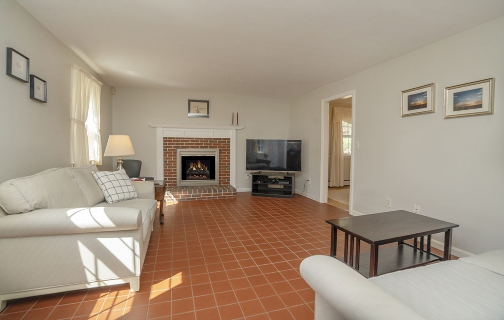 22 Elizabeth Street Amesbury, MA 01913 - Photo 10 of 38 a living room with furniture a fireplace and a flat screen tv
