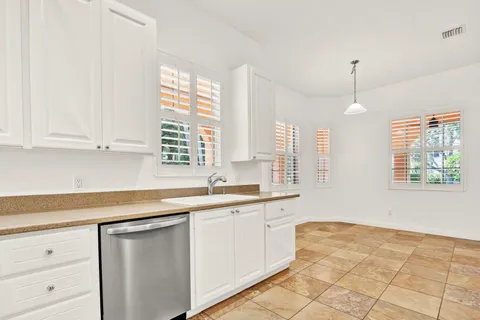 a kitchen with a sink stove and cabinets