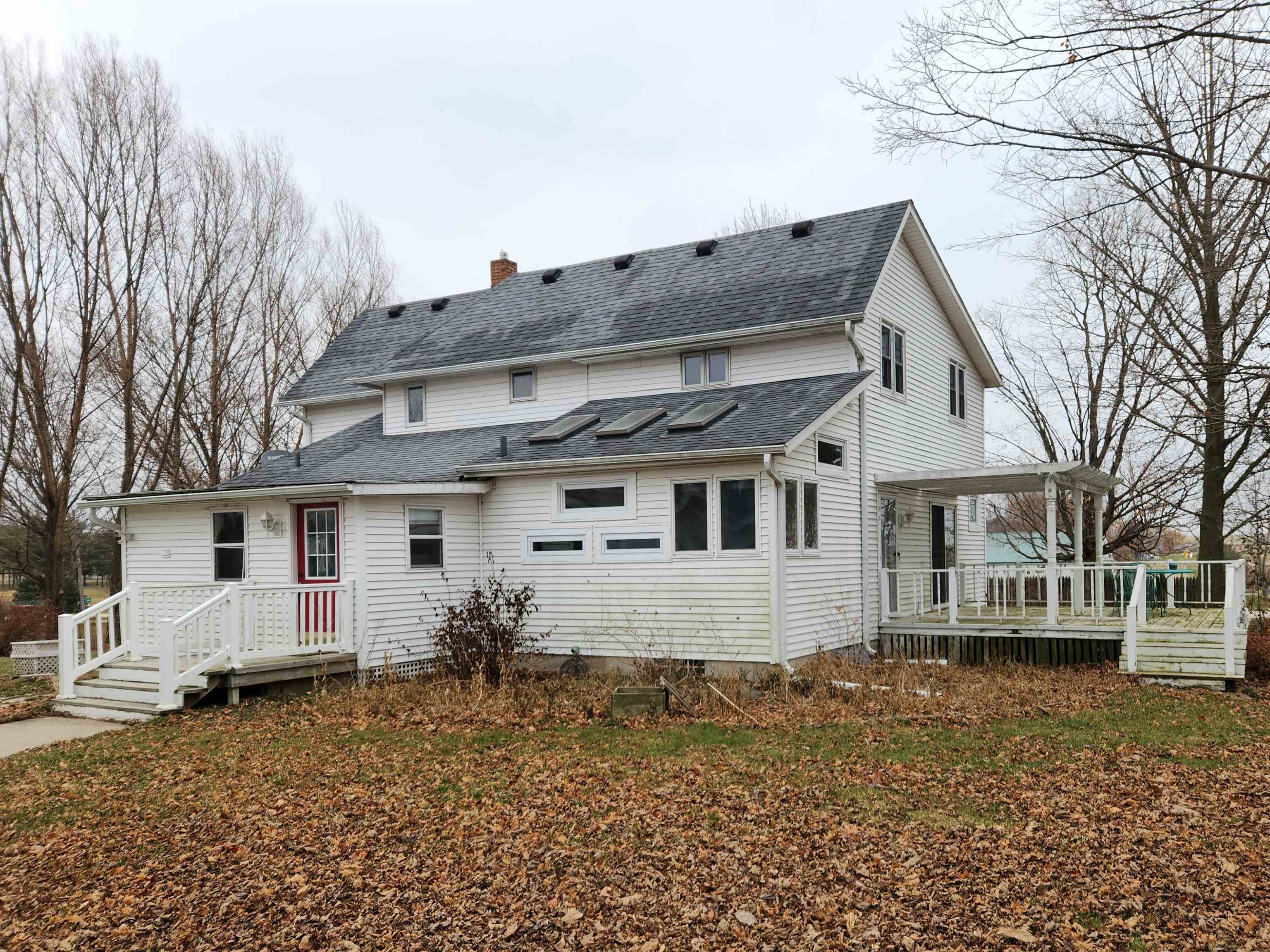 7082 South Hoosier Road Ashton, IL 61006 - Photo 1 of 48 a view of a white house with a large windows