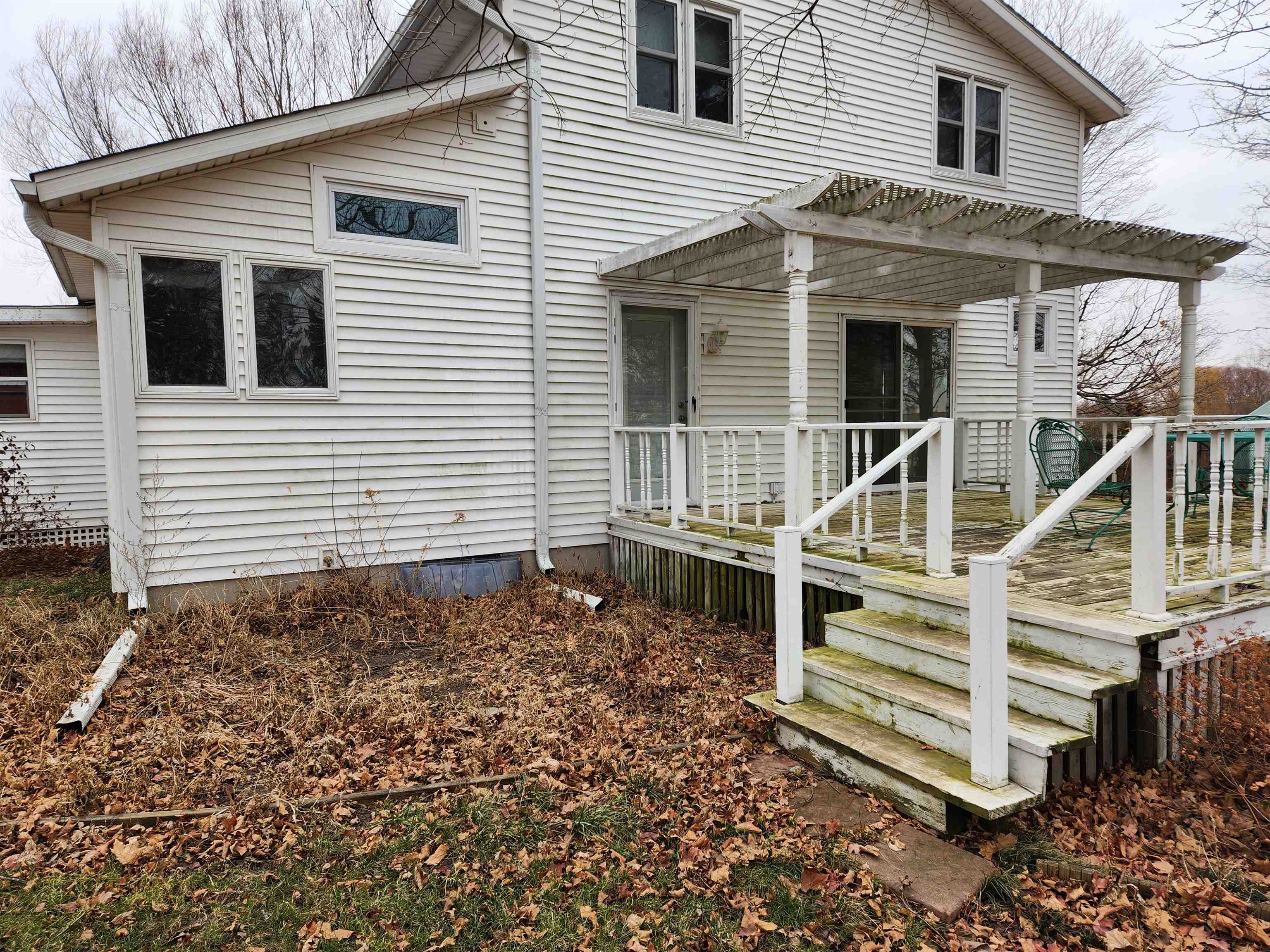7082 South Hoosier Road Ashton, IL 61006 - Photo 5 of 48 a view of a house with wooden fence