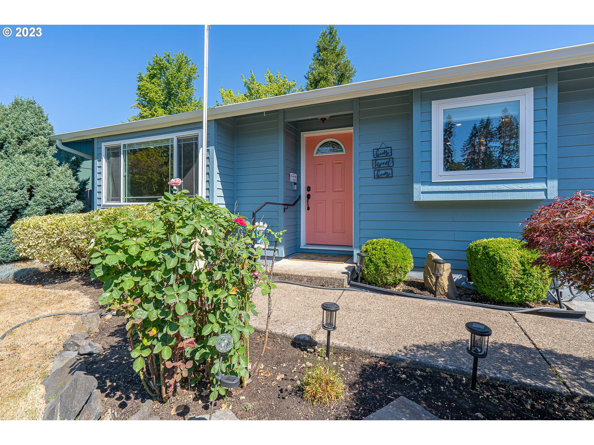 5040 Forsythia Street Springfield, OR 97478 - Photo 3 of 47 a front view of a house with garden