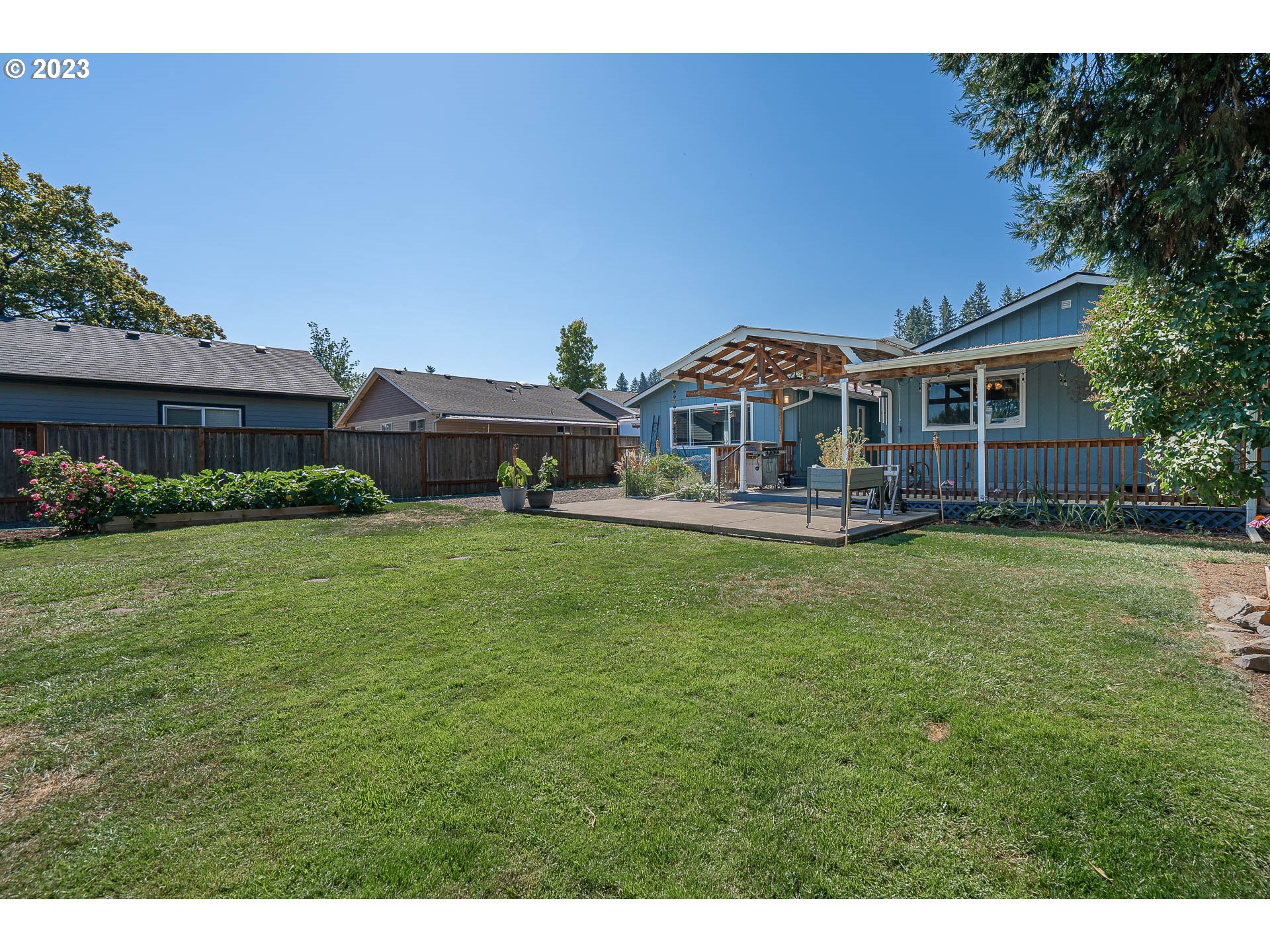 5040 Forsythia Street Springfield, OR 97478 - Photo 39 of 47 a front view of a house with a yard table and chairs