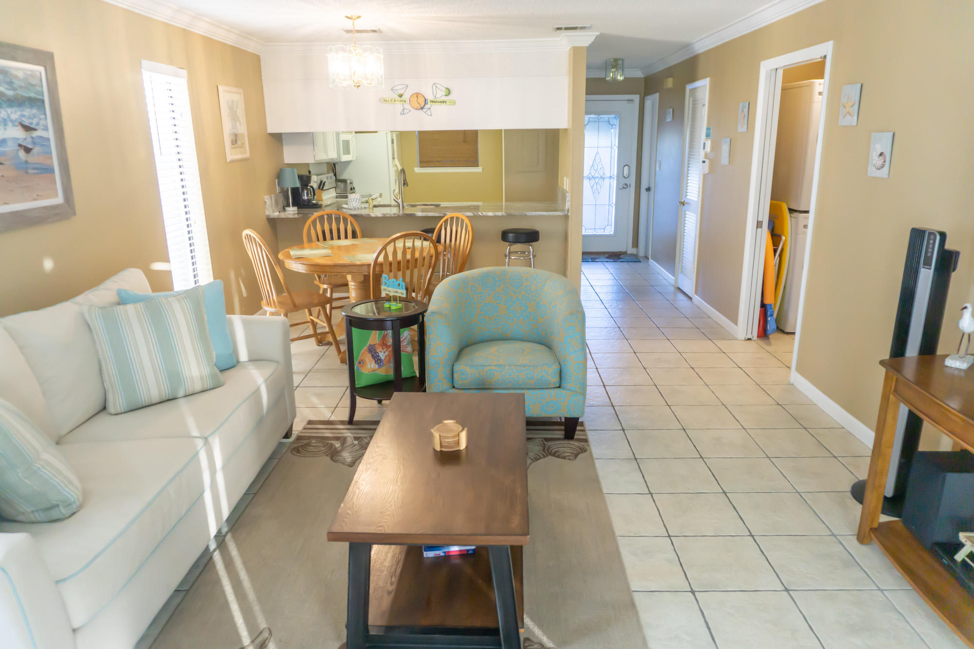 2000 Scenic Gulf Drive, Unit 5 Miramar Beach, FL 32550 - Photo 15 of 54 a living room with stainless steel appliances furniture a rug and a view of kitchen