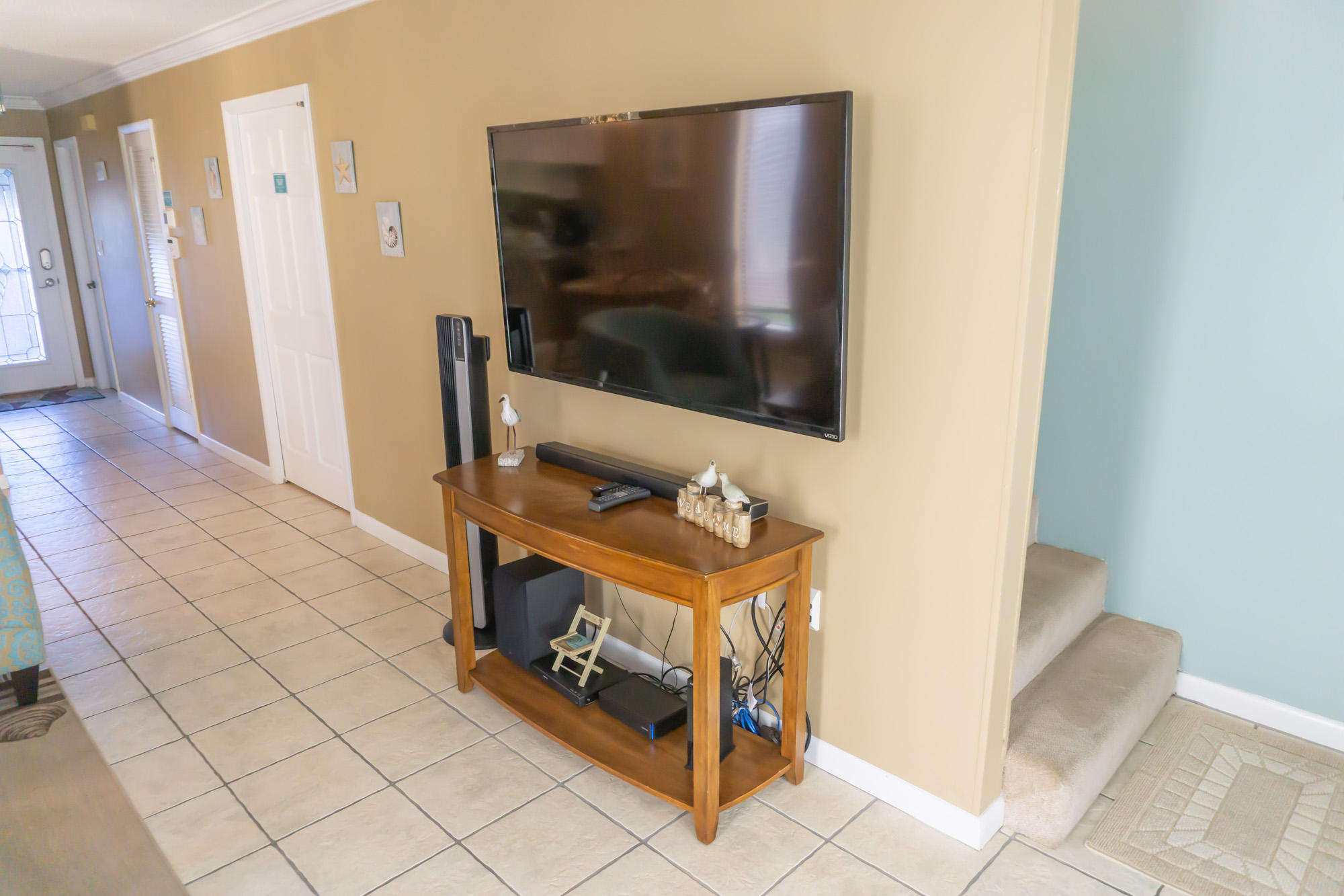 2000 Scenic Gulf Drive, Unit 5 Miramar Beach, FL 32550 - Photo 16 of 54 a living room with a flat screen tv and a rug