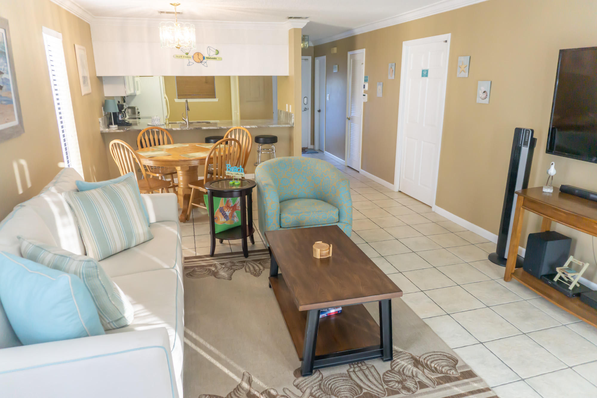 2000 Scenic Gulf Drive, Unit 5 Miramar Beach, FL 32550 - Photo 17 of 54 a living room with furniture and a flat screen tv