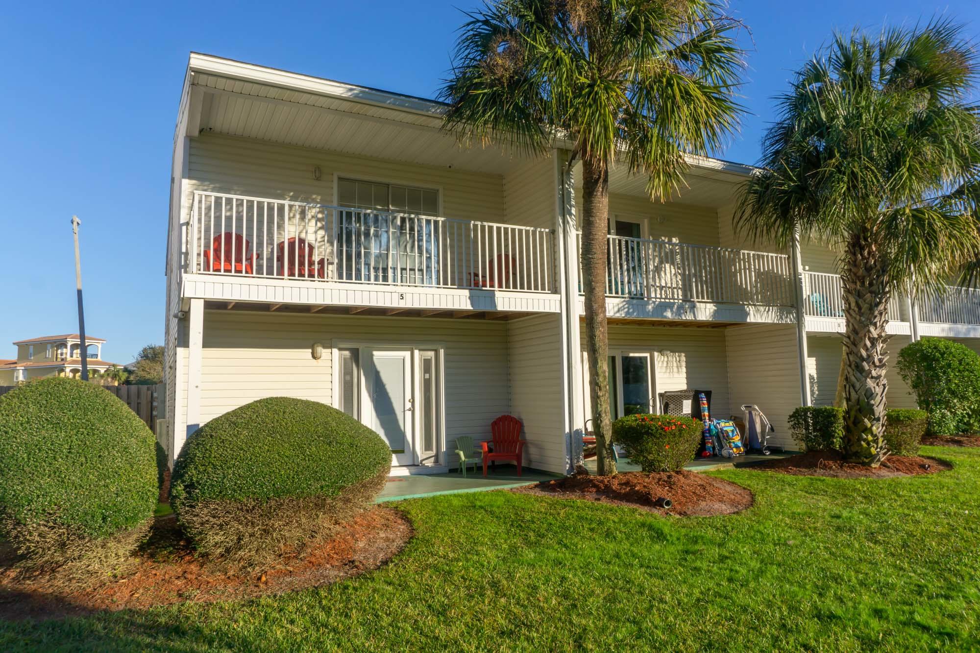 2000 Scenic Gulf Drive, Unit 5 Miramar Beach, FL 32550 - Photo 2 of 54 a front view of a house with garden