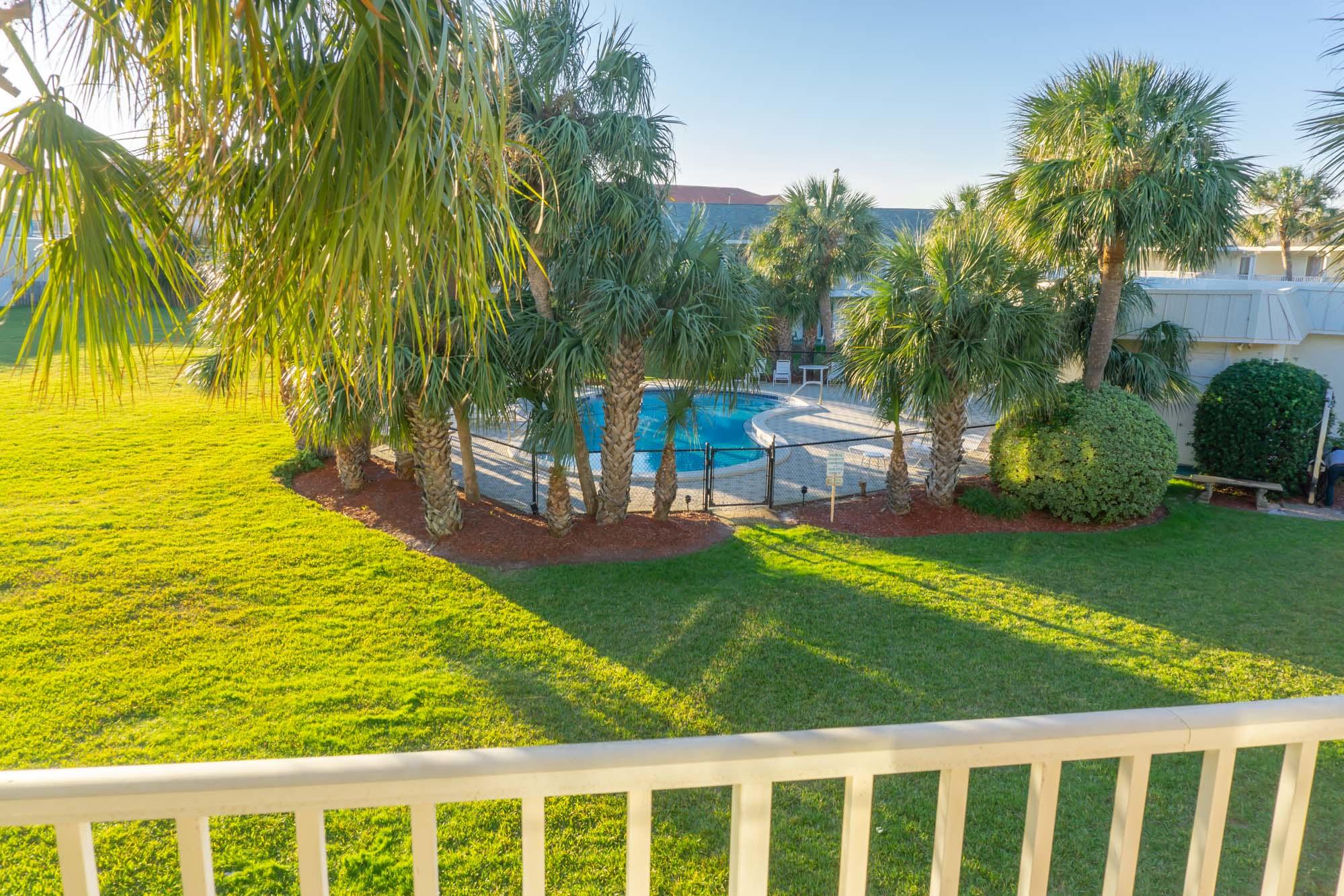 2000 Scenic Gulf Drive, Unit 5 Miramar Beach, FL 32550 - Photo 24 of 54 a view of a swimming pool with a garden