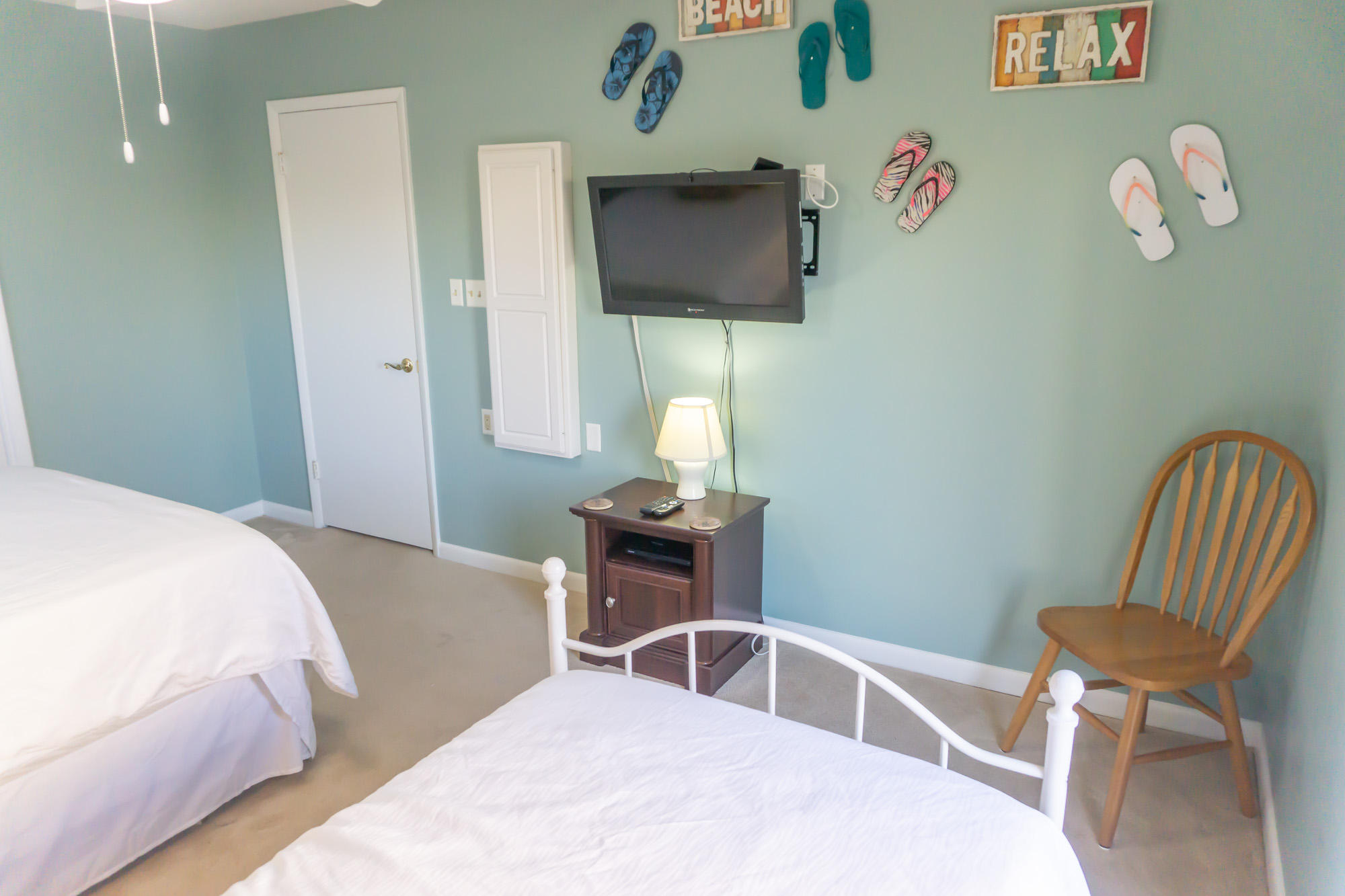 2000 Scenic Gulf Drive, Unit 5 Miramar Beach, FL 32550 - Photo 28 of 54 a bedroom with a bed and a chair