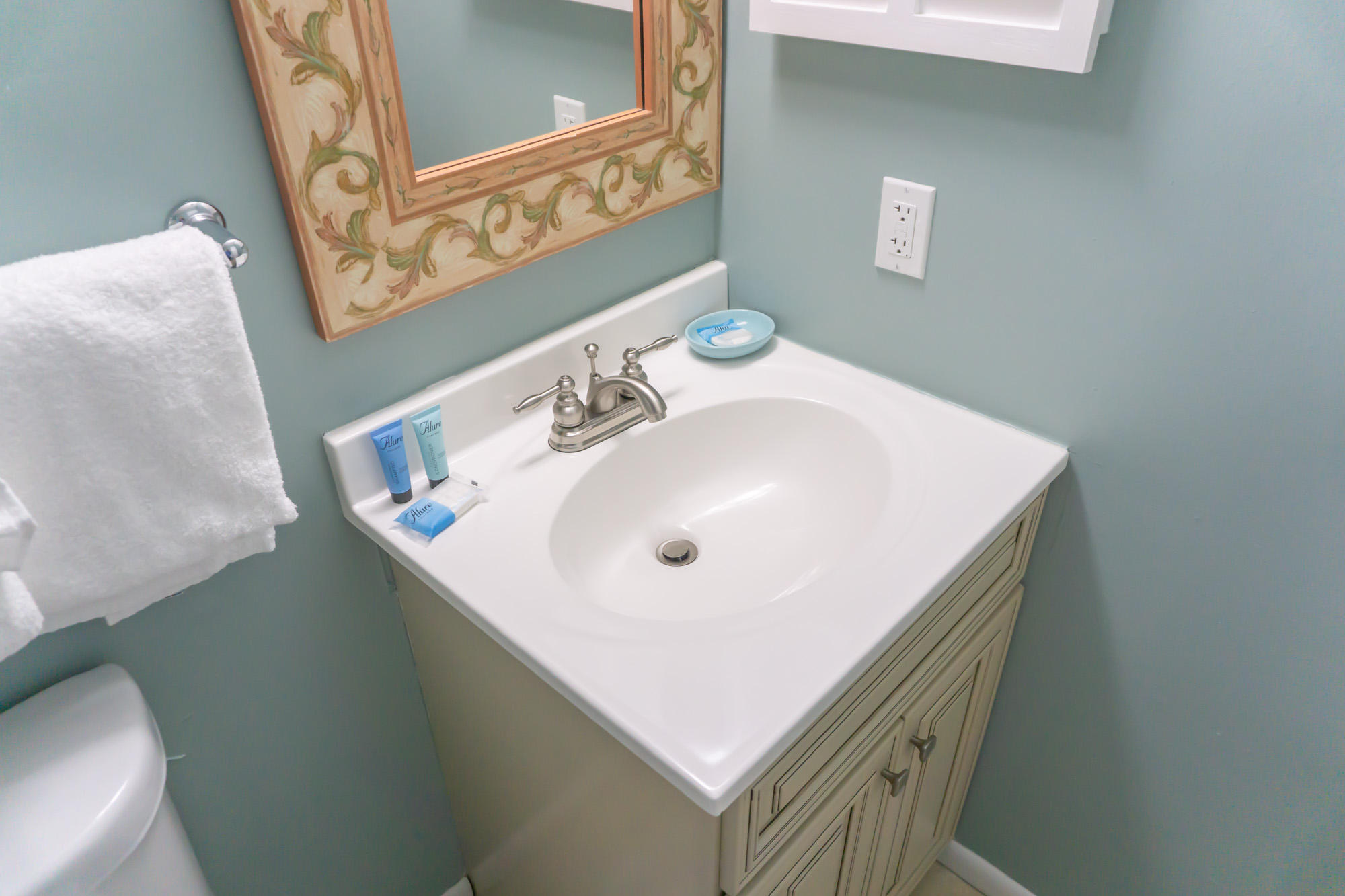 2000 Scenic Gulf Drive, Unit 5 Miramar Beach, FL 32550 - Photo 30 of 54 a white sink sitting under a bathroom mirror