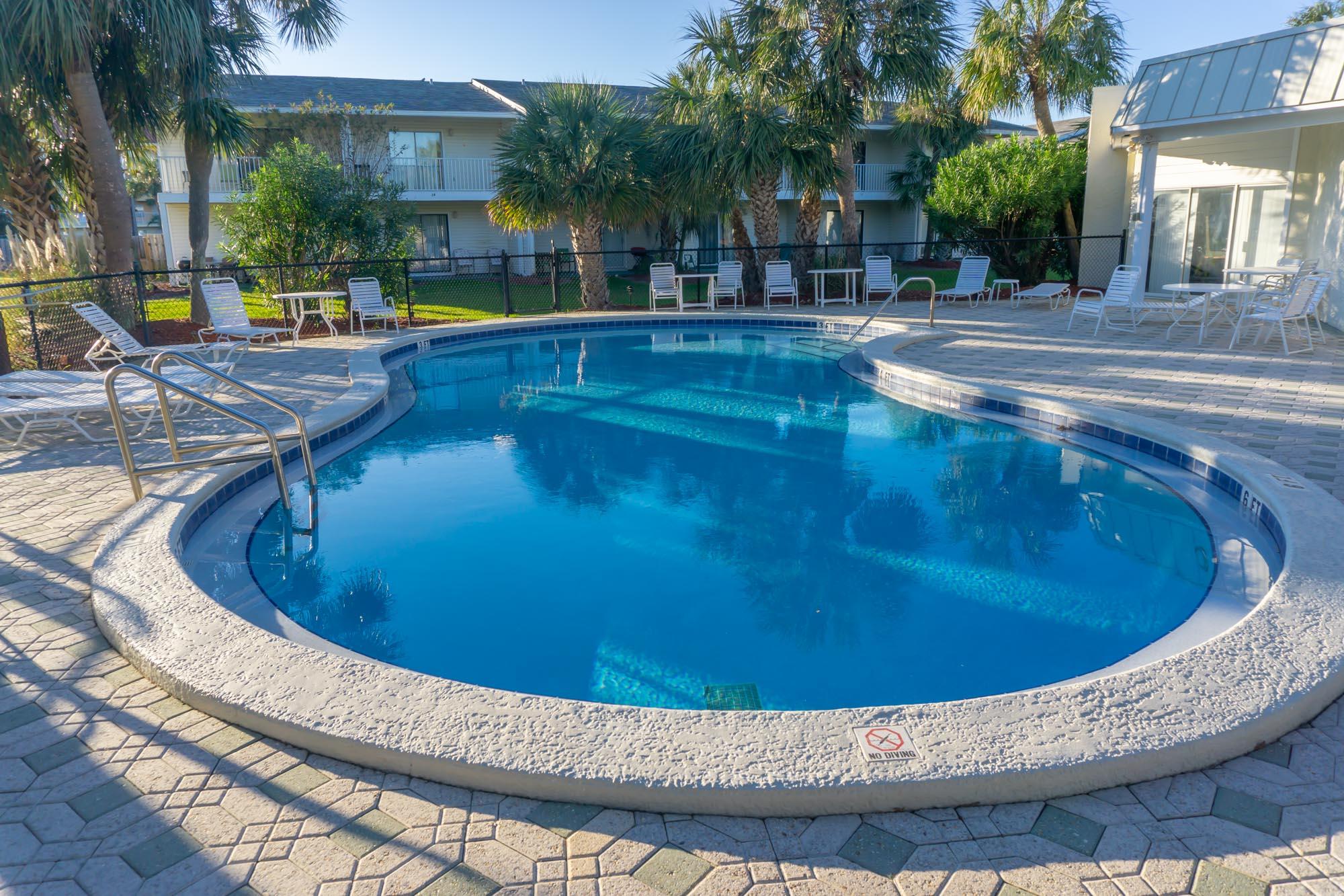 2000 Scenic Gulf Drive, Unit 5 Miramar Beach, FL 32550 - Photo 35 of 54 a view of a swimming pool with outdoor seating