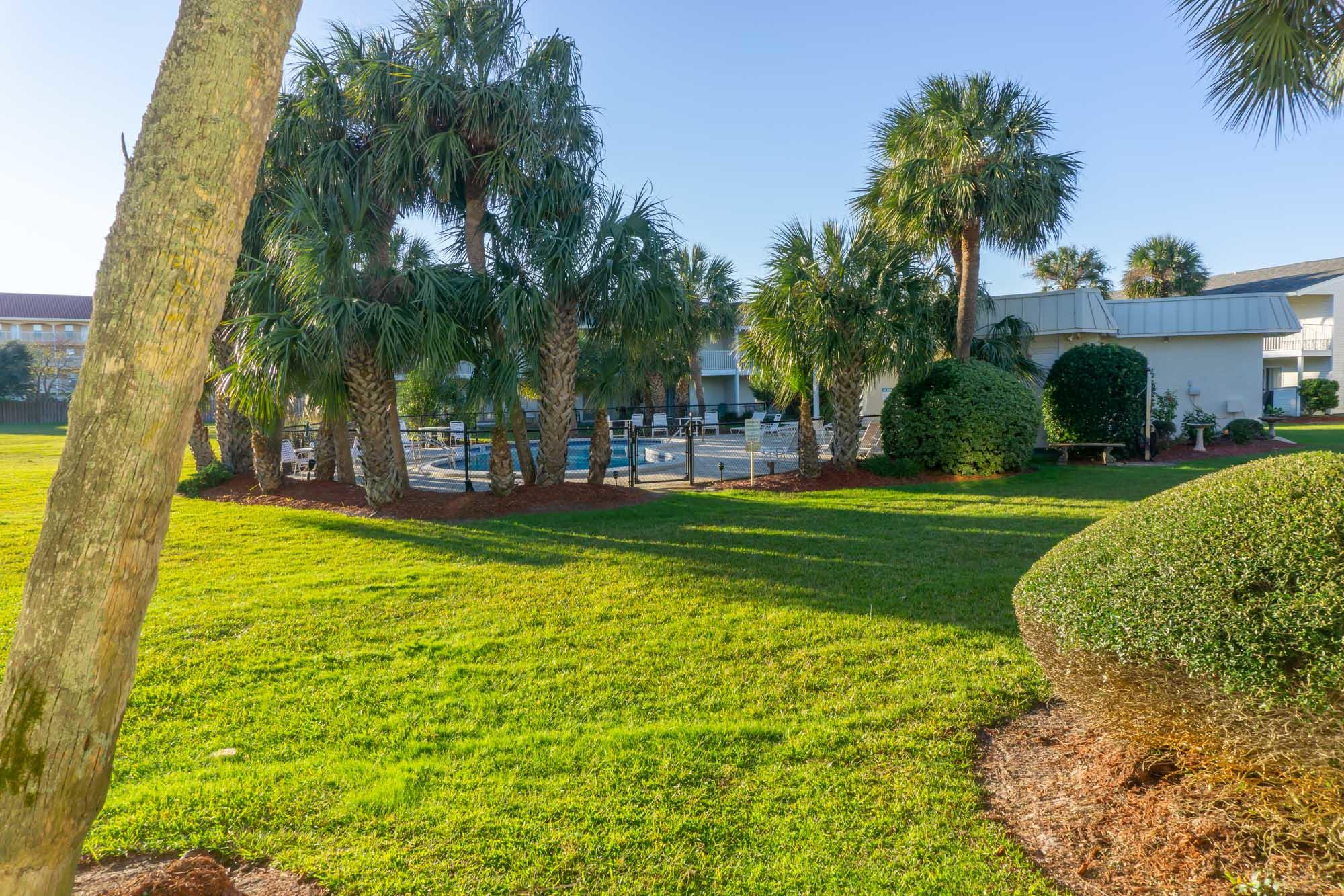 2000 Scenic Gulf Drive, Unit 5 Miramar Beach, FL 32550 - Photo 6 of 54 a view of yard with swimming pool and green space