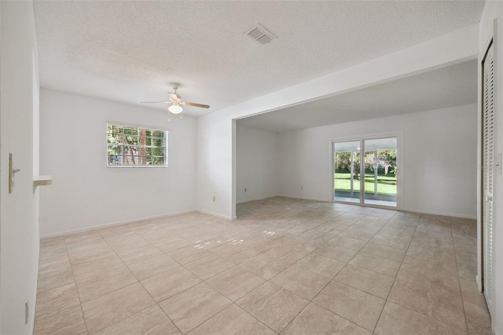 498 Green Spring Circle Winter Springs, FL 32708 - Photo 5 of 20 an empty room with windows and ceiling fan