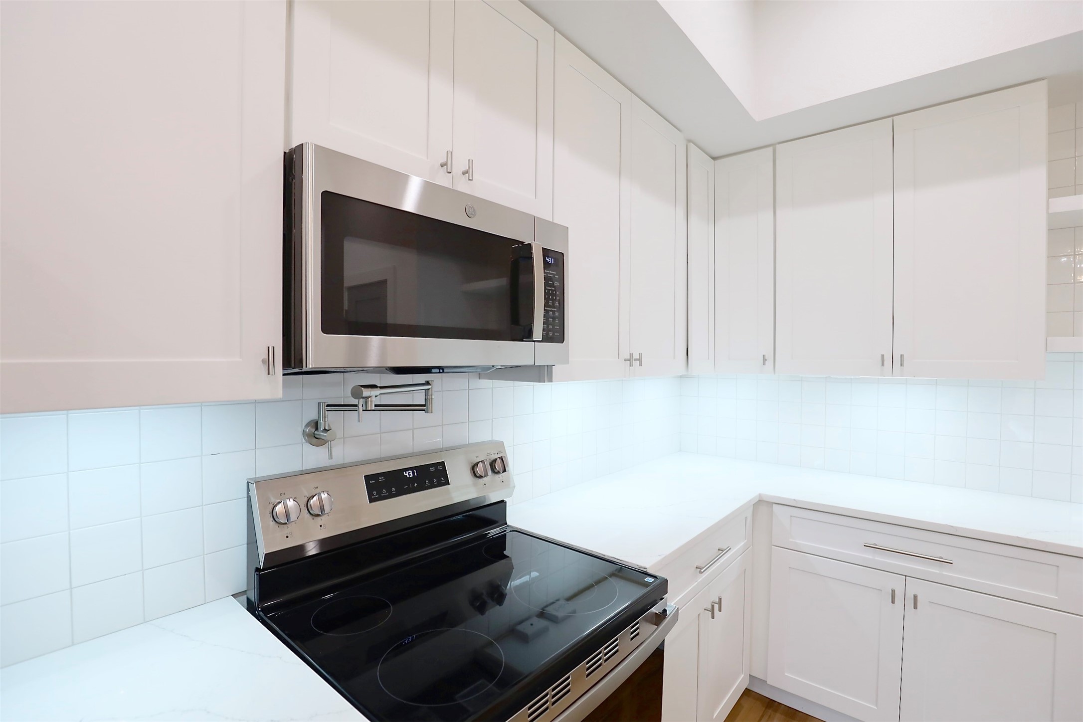 421 East 41st Street Houston, TX 77022 - Photo 13 of 32 a kitchen with a stove and a microwave